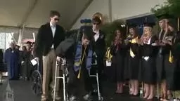 Paralyzed student, Austin Whitney, walks at graduation